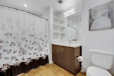a bathroom with a shower curtain and a toilet at Apart Hotel at Chinatown in Los Angeles