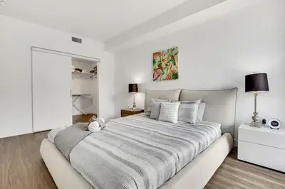 a white bedroom with a large bed in it at Apart Hotel at Chinatown in Los Angeles