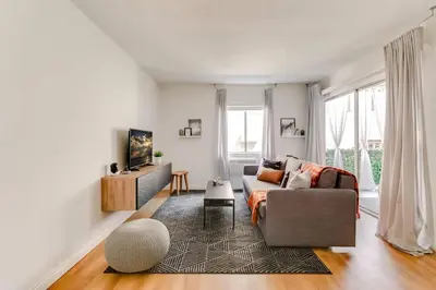a living room with a couch and a tv at Sophisticated Long Beach Suite with Patio Dining and Parking NRP21-00185 in Long Beach