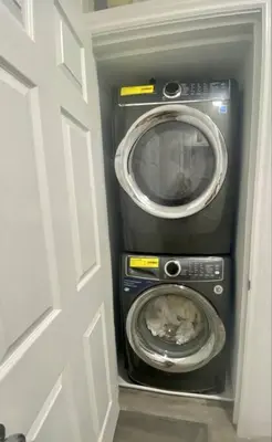a washer and dryer in a room with a door at Blanquitas Home in Long Beach