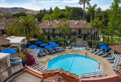 a view of the pool at a resort with chairs and umbrellas at Westlake Village Inn in Westlake Village