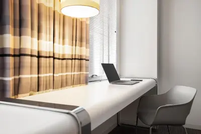 a laptop computer sitting on a desk with a chair at The Delphi Downtown LA in Los Angeles