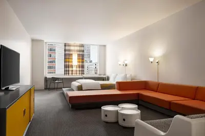 a hotel room with a couch and a bed at The Delphi Downtown LA in Los Angeles
