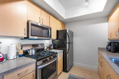 a kitchen with a stove and a refrigerator at 1 Luxury Apartment in Los Angeles