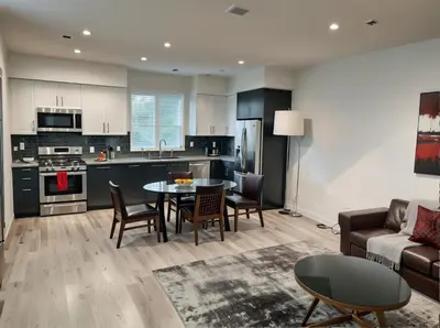 a kitchen and living room with a couch and a table at Hollywood Homes Free parking close to all things LA in Los Angeles