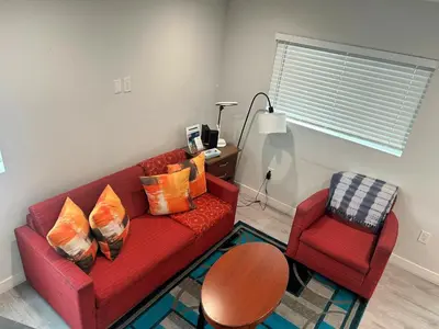 a living room with a red couch and a chair at Hollywood Homes Free parking close to all things LA in Los Angeles