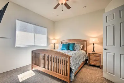 a bedroom with a crib and a ceiling fan at 5 Mi to Universal Studios Family Gem with Hot Tub! in Burbank