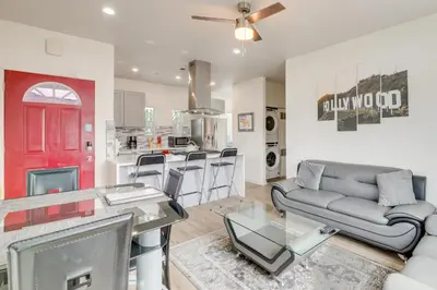 a living room with a couch and a red door at 5 Mi to Universal Studios Family Gem with Hot Tub! in Burbank