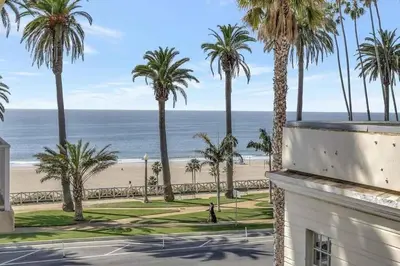 a view of the beach and palm trees from a building at 10 Cozy apartment heart of Santa Monica in Los Angeles