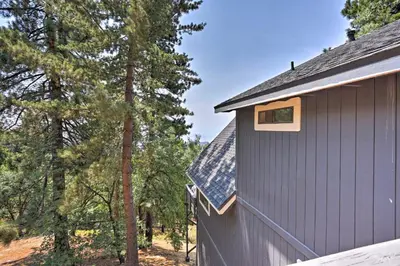 a house with solar panels on the side of it at A-Frame Cali Cabin with Unobstructed Valley Views! in Running Springs