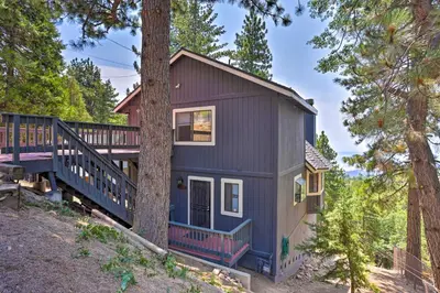 a house in the woods with a tree at A-Frame Cali Cabin with Unobstructed Valley Views! in Running Springs