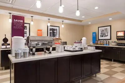 a kitchen with a counter top with a food at Hampton Inn & Suites San Bernardino in San Bernardino