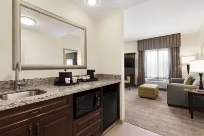 a hotel room with a sink and a mirror at Hampton Inn & Suites San Bernardino in San Bernardino