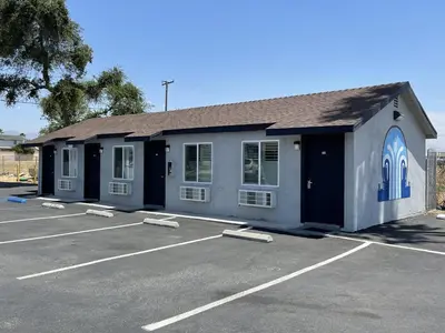 a building with a parking lot in front of it at Fontana Inn in Fontana