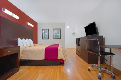 a bedroom with a bed and a desk and a computer at Mojave Hotel in Mojave
