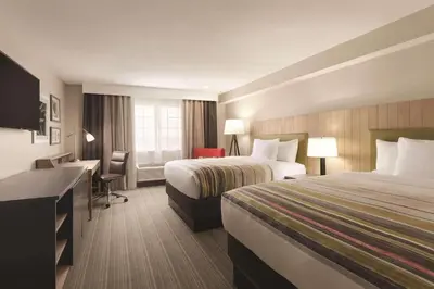 a hotel room with two beds and a desk at Country Inn & Suites by Radisson, Bakersfield, CA in Bakersfield