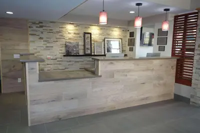 a bar in a restaurant with wooden walls and lights at Country Inn & Suites by Radisson, Bakersfield, CA in Bakersfield