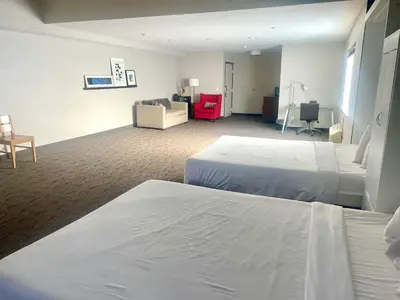 a hotel room with two beds and a couch at Country Inn & Suites by Radisson, Bakersfield, CA in Bakersfield
