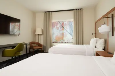 a hotel room with two beds and a window at Fairfield by Marriott Inn & Suites Palmdale West in Palmdale