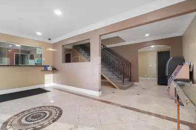 a living room with a staircase in a house at Santa Fe Inn Los Angeles in Huntington Park