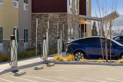 a blue car parked in a parking lot next to a building at TownePlace Suites By Marriott Tehachapi in Tehachapi
