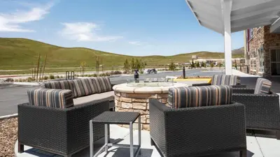 a patio with chairs and a table with a fountain at TownePlace Suites By Marriott Tehachapi in Tehachapi