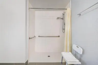 a white bathroom with a shower and a toilet at Best Western Desert Winds in Mojave