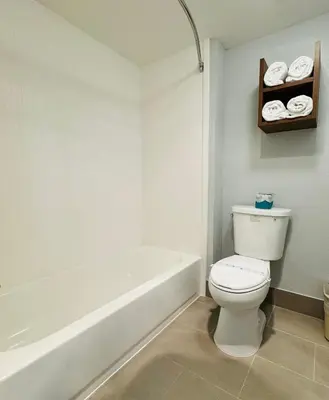 a bathroom with a white toilet and a bath tub at Best Western Desert Winds in Mojave