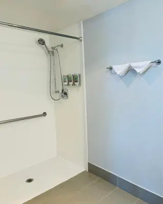a bathroom with a shower with a glass door at Best Western Desert Winds in Mojave