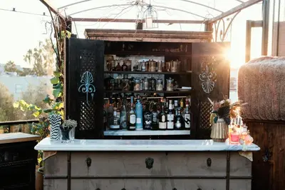 a bar with a bunch of bottles on it at Petit Ermitage in Los Angeles