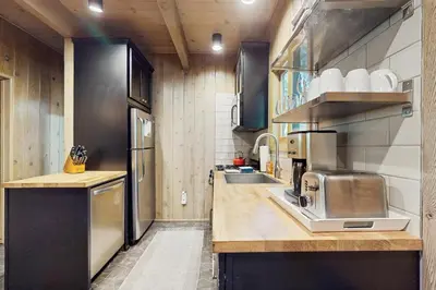 a small kitchen with a sink and a refrigerator at Wooded Comfort in Lake Arrowhead