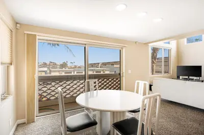 a living room with a white table and chairs and a window at Seaside Getaway in Oxnard