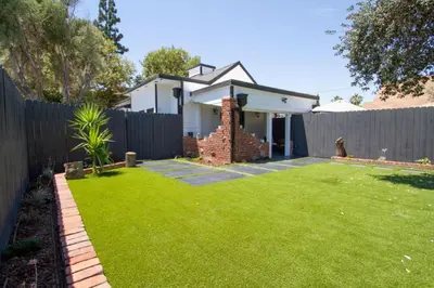 a backyard with a fence and a house at Dreamy Farmhouse in Studio City in Los Angeles