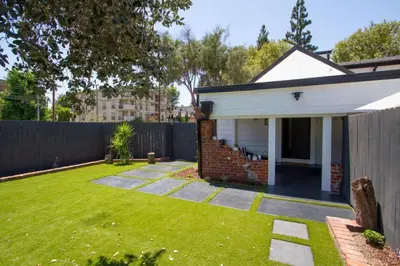a backyard with a house and a fence at Dreamy Farmhouse in Studio City in Los Angeles