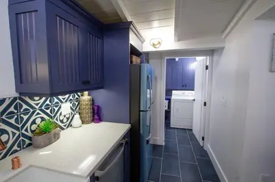a kitchen with blue cabinets and a tile floor at Dreamy Farmhouse in Studio City in Los Angeles