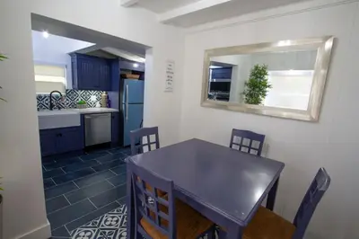 a kitchen with a table and chairs and a mirror at Dreamy Farmhouse in Studio City in Los Angeles