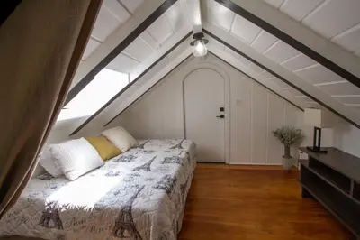 a bedroom with a bed in a attic at Dreamy Farmhouse in Studio City in Los Angeles