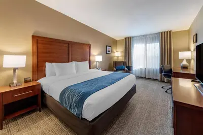 a hotel room with a large bed and a desk at Comfort Inn & Suites Ventura Beach in Ventura