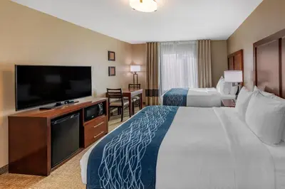 a hotel room with a large bed and a flat screen tv at Comfort Inn & Suites Ventura Beach in Ventura