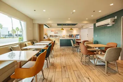 a restaurant with tables and chairs and a counter at Comfort Inn & Suites Ventura Beach in Ventura