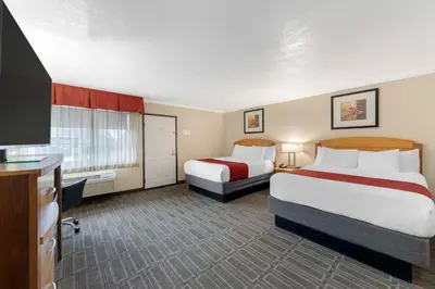 a hotel room with two beds and a flat screen tv at Best Western Plus Ontario Airport & Convention Center in Ontario