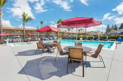 a patio with tables and chairs next to a pool at Best Western Plus Ontario Airport & Convention Center in Ontario