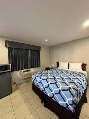 a bedroom with a large bed and a window at Rodeway Inn Ventura Midtown in Ventura