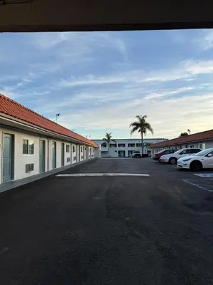 a parking lot with cars parked in front of a motel at Rodeway Inn Ventura Midtown in Ventura