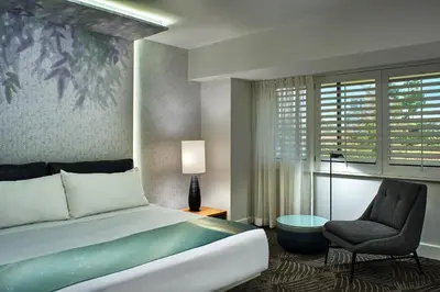 a hotel room with a bed and a chair at W Los Angeles – West Beverly Hills in Los Angeles