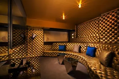 a room with a leather couch and blue pillows at W Los Angeles – West Beverly Hills in Los Angeles
