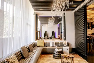 a living room with a couch and a chandelier at W Los Angeles – West Beverly Hills in Los Angeles
