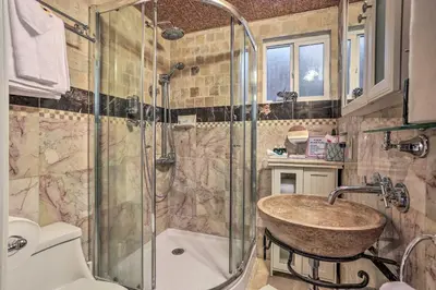 a bathroom with a sink and a shower at 1 Mi to Lake Gregory Boho Crestline Cabin in Crestline