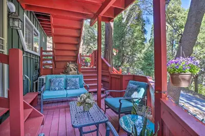 a red porch with blue chairs and a table at 1 Mi to Lake Gregory Boho Crestline Cabin in Crestline