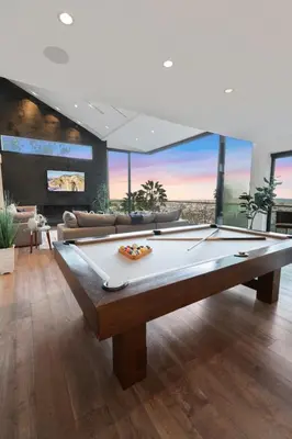 a pool table in a living room with a view at Franklin Modern in Los Angeles
